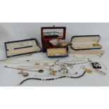 A collection of costume jewellery including cased buttons, marcasite necklace, silver bracelet,