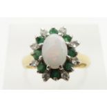 An 18ct gold ring set with an opal cabochon, emeralds and diamonds, 4.8g, size M