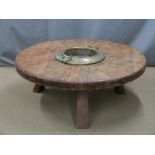 Possibly tribal circular table with central brass container, diameter 120cm height 45cm