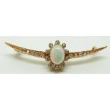 A late Victorian crescent shaped brooch set with an oval opal cabochon and diamonds, in original