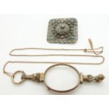 A lorgnette and a silver brooch