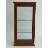 An oak glass display cabinet with two adjustable glass shelves approximately, 38 x 26 x 77cm