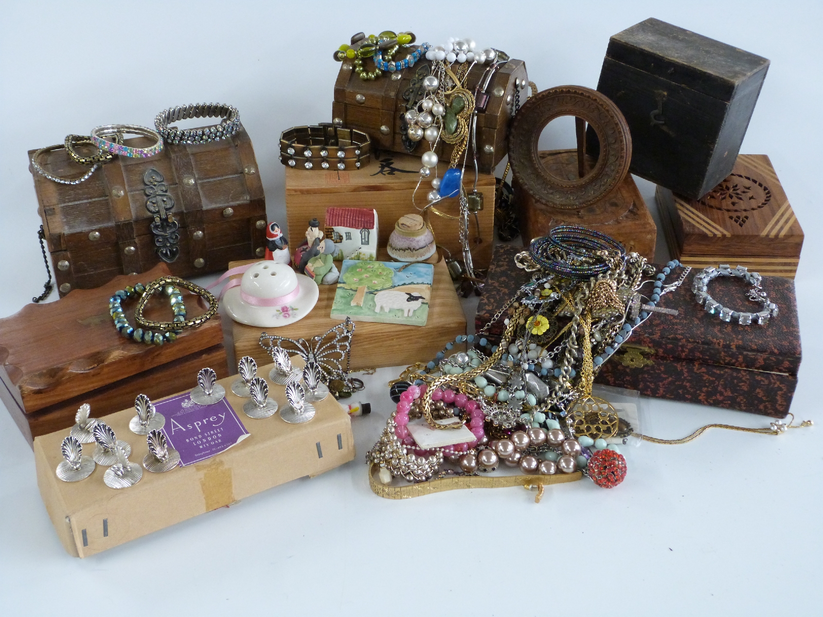 A collection of wooden jewellery boxes and costume jewellery including beads, bracelets etc