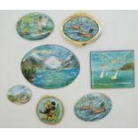 Seven enamel plaques painted with country scenes, ducks, fairies and flowers