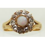 Victorian 18ct gold ring set with an opal cabochon surrounded by old cut diamonds, size J, in