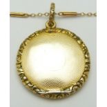 A 9ct gold necklace (2.5g)and Victorian locket with engine turned decoration and textured border,