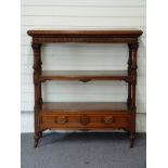 Victorian oak three tier what-not with two drawers under, the ornately carved columns leading to