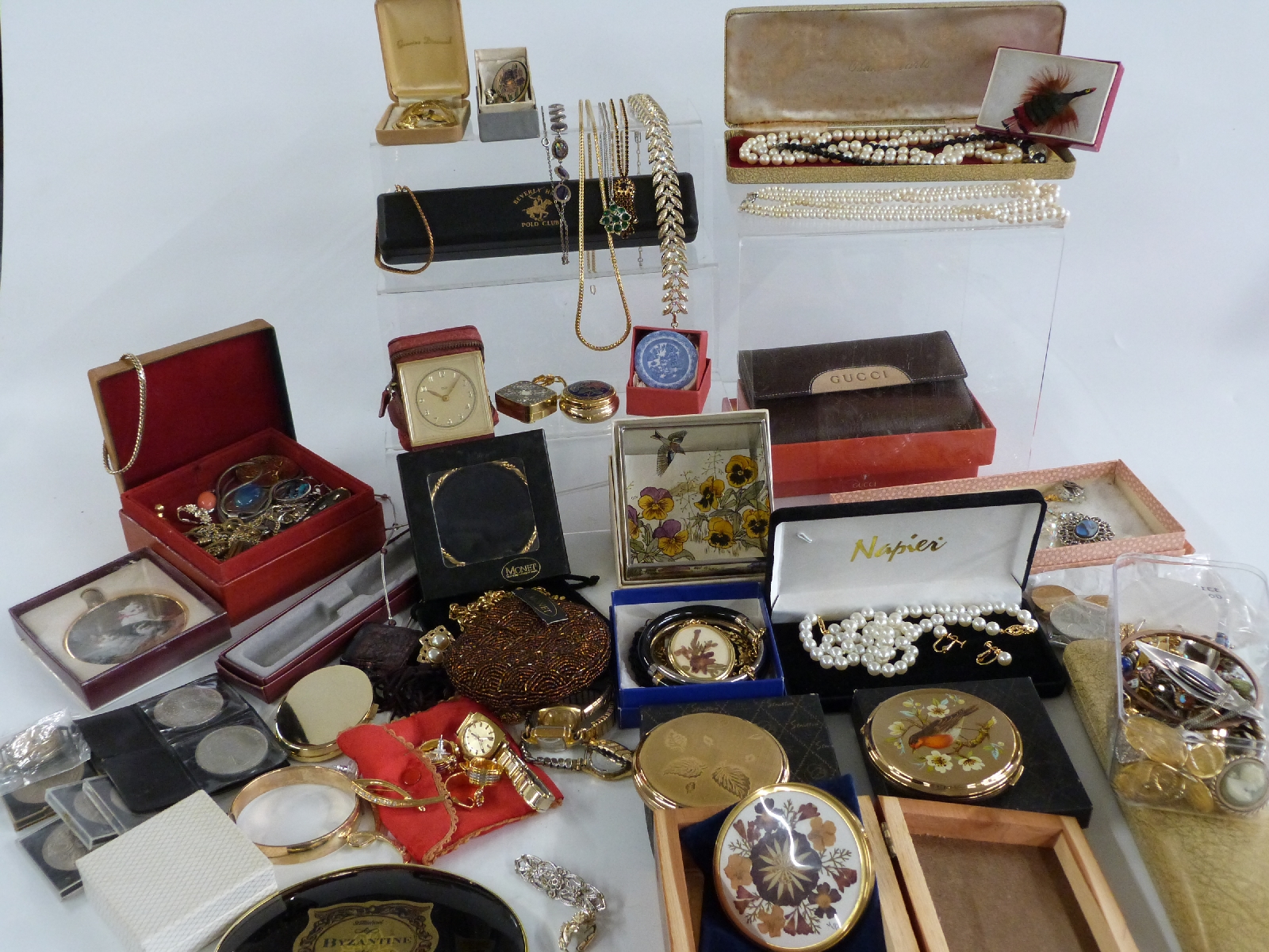 A collection of costume jewellery including Monet, Napier, Stratton compacts, brooches, necklaces,
