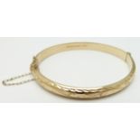 A 9ct gold bangle with cut out decoration, 8.3g