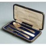 Cased hallmarked silver christening set comprising spoon, knife and fork, Sheffield 1921 and 1928
