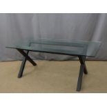 Modern glass topped table with black X frame support L180 x W80 x H73cm
