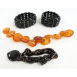 Two jet bracelets, tortoiseshell bracelet and amber buttons