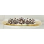 An 18ct gold ring set with five diamonds, 2.7g, size W