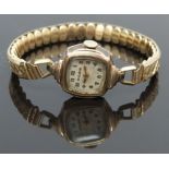 Bulova gold plated ladies wristwatch with gold hands and Arabic numerals, silver dial and signed