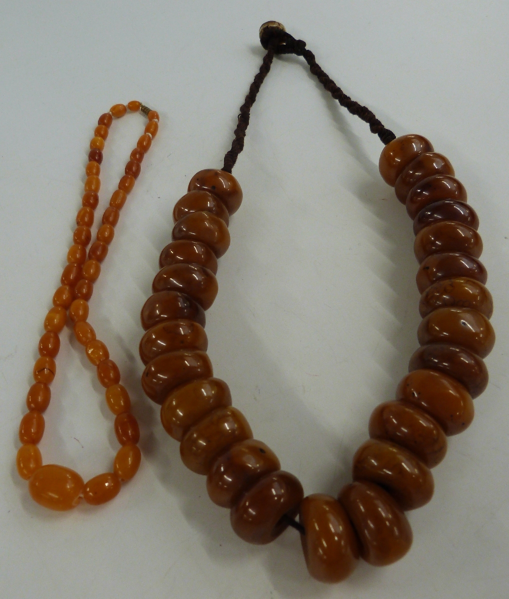 A small Baltic amber necklace made up of graduated oval beads (15g) and another amber necklace (