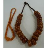 A small Baltic amber necklace made up of graduated oval beads (15g) and another amber necklace (