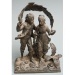 A 19th/20thC spelter figural group of two children using a banana/palm leaf as a sunshade on