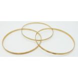 Three 18ct gold bangles with cut out decoration, 13.2g