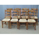 Eight rush seated dining chairs (two carvers and six chairs) with shaped back spars and turned cross