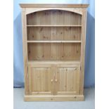 Set of pine shelves with cupboards below, W122 x D35 x H183cm