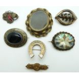Victorian pinchbeck brooch set with black enamel and banded agate, a horseshoe brooch reading Good