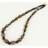 A beaded necklace made up of 18thC Islamic beads