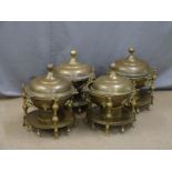 Four decorative brass covered warmers, diameter 45cm
