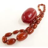 An amber necklace (22g) and large cherry amber bead (43g)