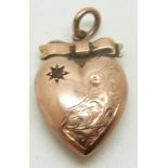 A 9ct rose gold heart pendant set with a garnet in a star setting, 1g