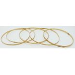 Four 18ct gold bangles with cut out decoration, 13.3g