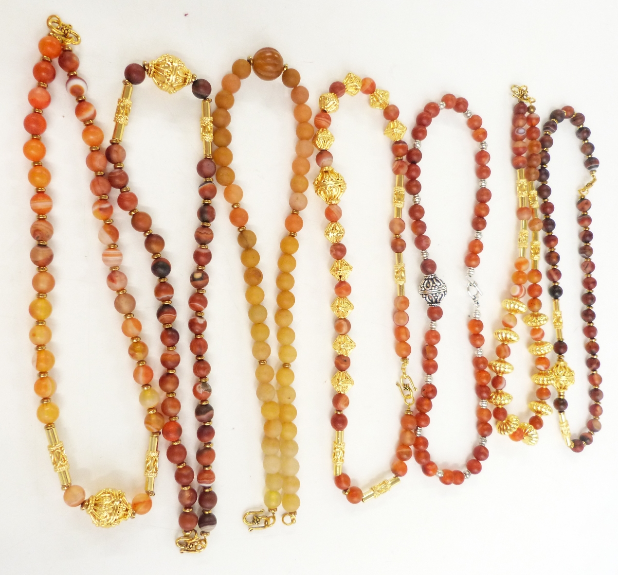 Seven agate and gilt beaded necklaces