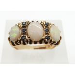 A 9ct gold ring set with opals and sapphires, 4.5g, size P