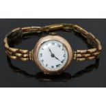 Continental 9ct gold ladies wristwatch with black Roman numerals, white enamel dial and 15 jewel