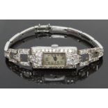 Art Deco platinum ladies wristwatch with diamond set case and bracelet, blued hands, black Arabic