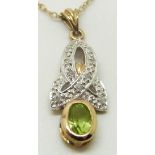 A 9ct gold pendant set with a oval peridot and diamonds, 2.5 x 1cm, 1.9g