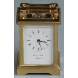 Carriage clock in brass case with reeded decoration, enamel Roman dial signed Morrell and Hilton,