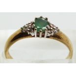 A 9ct gold ring set with an emerald and diamonds, 1.6g, size N