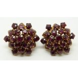 A pair of 14k gold earrings set with clusters of round cut rubies, 2.2cm diameter, 10.6g