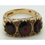 A 9ct gold ring set with three large oval garnets, 4.7g, size P