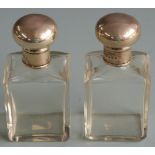 Pair of George V hallmarked silver topped dressing table scent bottles, London 1916 maker Charles