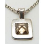 De Beers 18ct white gold pendant set with an uncut brown diamond and a small round cut diamond, 15.