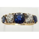 An 18ct gold ring set with three sapphires, the centre stone measuring approximately 1ct, and two