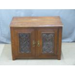Small oak cabinet with carved doors, W82 x D52 x H60cm