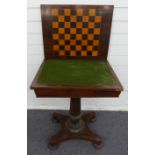 A 19thC rosewood games table the folding swivel top opening to reveal a chess/draughts board and