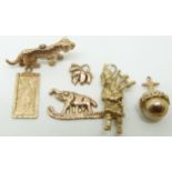 A collection of 9ct gold to include tiger, bagpiper, elephant, St Christopher, etc, 15,7g