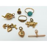 A collection of charms including 9ct gold heart, tea pot, pig, etc, a 9ct gold T bar, and a 9ct gold