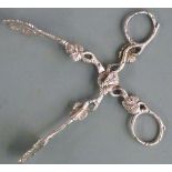 Pair of Victorian hallmarked silver sugar nips with foliate decoration, the hinge surmounted by a