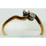 An 18ct gold ring set with two diamonds, 2.3g, size R