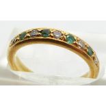 An 18ct gold half eternity ring set with alternating emeralds and diamonds, 4.3g, size K