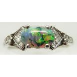 Art Deco platinum ring set with an oval opal cabochon and square, baguette and round cut diamonds,